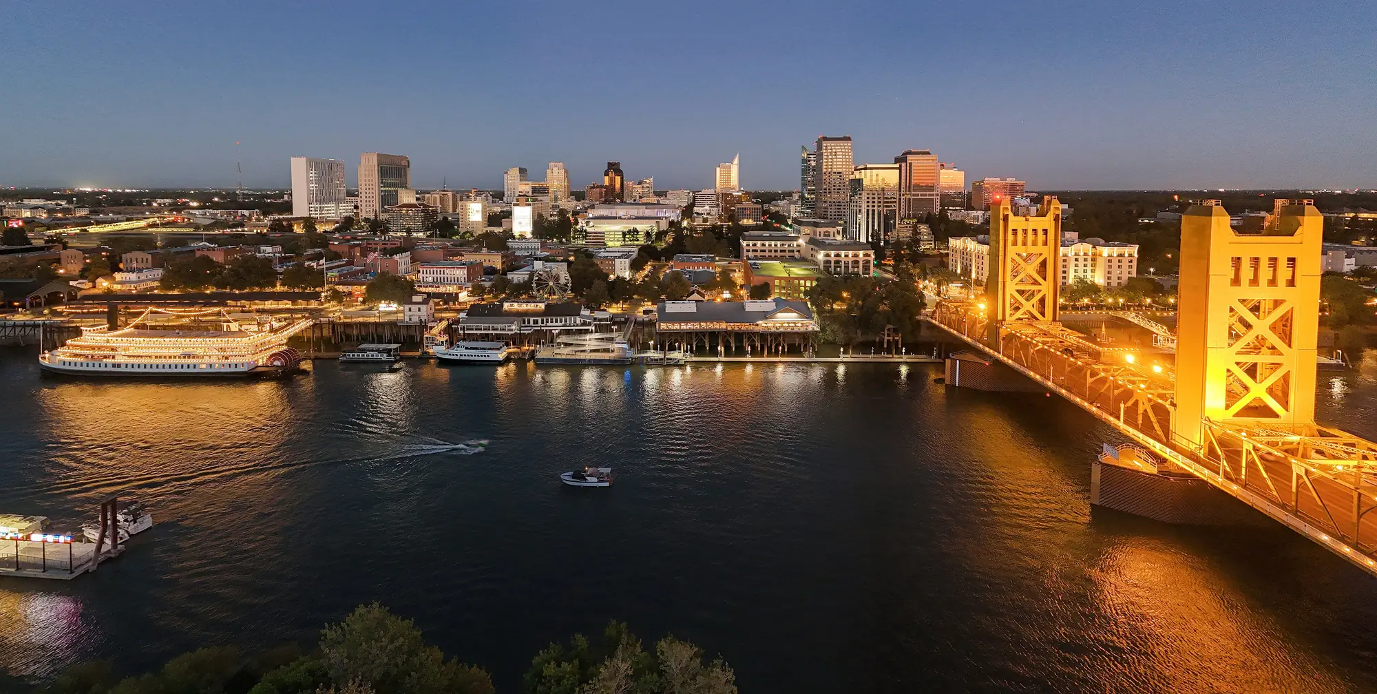 Downtown Sacramento and Tower Bridge over the Sacramento River at dusk